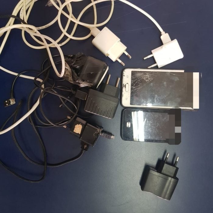 Um adolescente foi apreendido depois ser flagrado tentando arremessar celulares e carregadores por cima do muro do presídio de Águas Lindas. (Foto: Divulgação/DGAP)