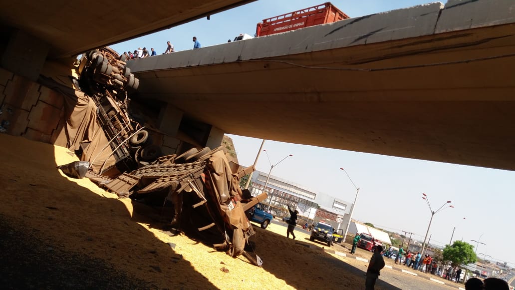 Carreta com 40 toneladas de milho cai de viaduto sobre carro, em Itumbiara