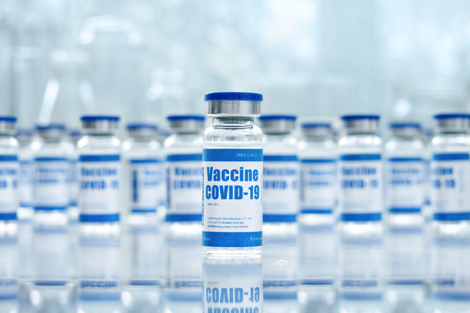 Covid 19 corona virus vaccine vial bottles for intramuscular injections on medical pharmaceutical industry background. Coronavirus cure manufacture, flu treatment drug pharmacy production concept.