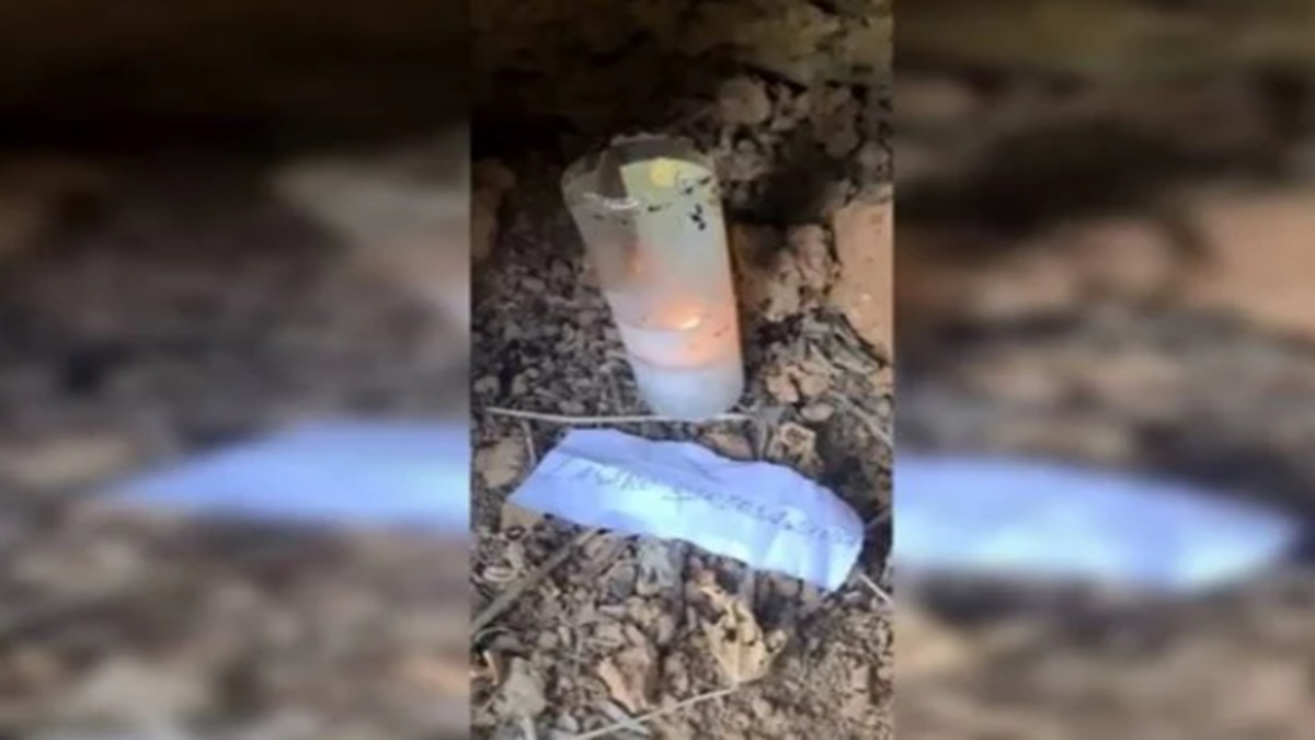 A Polícia encontrou uma espécie de altar com vela acesa e o nome de Lázaro escrito em um papel, em mata de Edilândia. (Foto: reprodução)