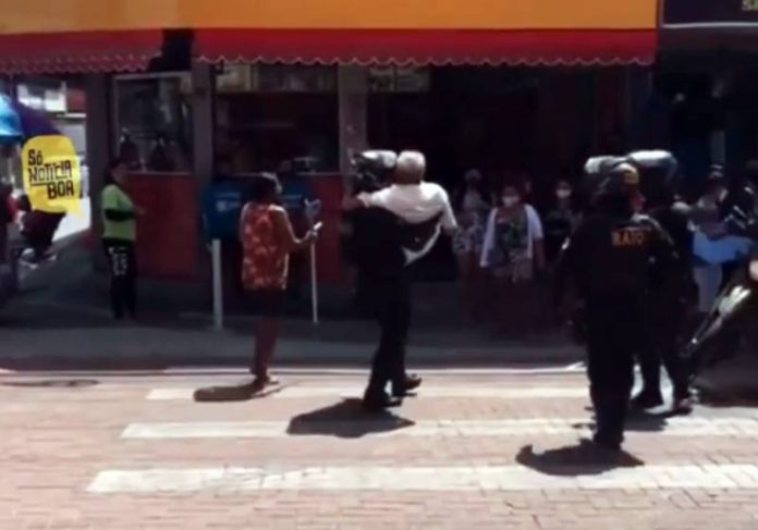 Idoso apresentava dificuldades em atravessar e o policial decidiu pegá-lo no colo para ajudá-lo