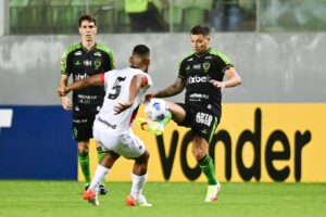 Willian Maranhão tenta tomar a bola do jogador do América-MG