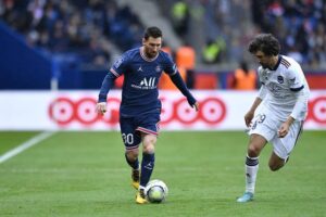 Messi tenta passar pelo marcador em jogo do Campeonato Francês