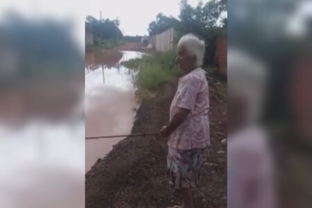 Idosa 'pesca' na rua para protestar contra alagamentos em Anápolis