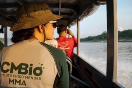 Imagem de uma mulher em uma canoa com o uniforme da ICMBio