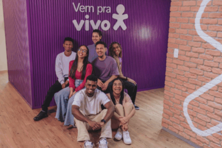 Imagem de jovens em frente a logo da Vivo