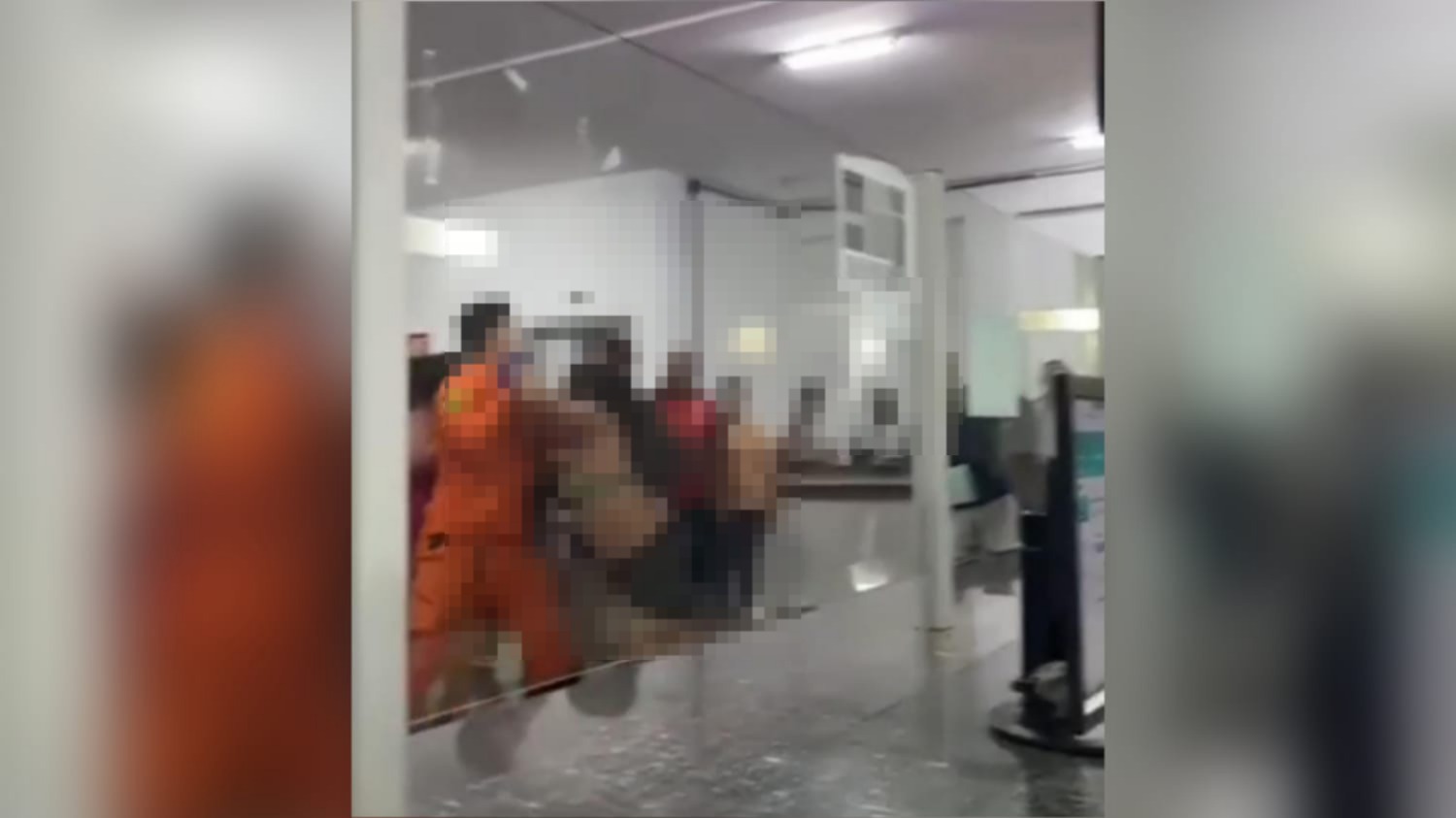 Momento em que o bombeiro tenta segurar a mulher