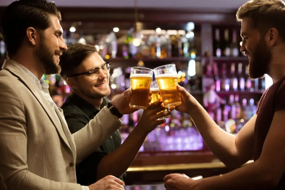 cheerful-young-men-toasting-with-beer