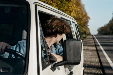 Homem dirige van branca na estrada