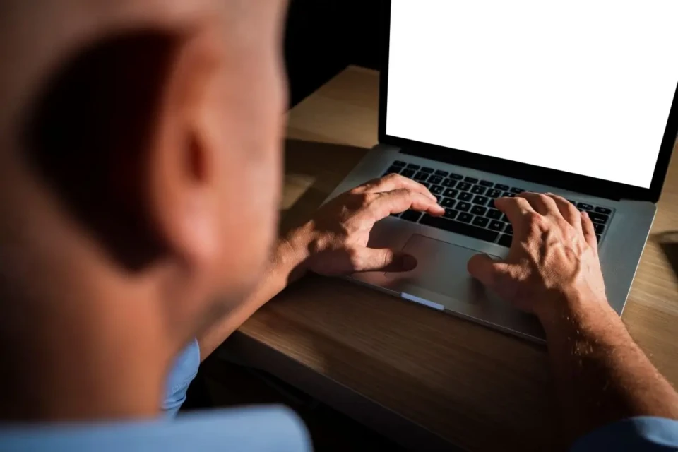 unrecognisable-casual-man-typing-laptop