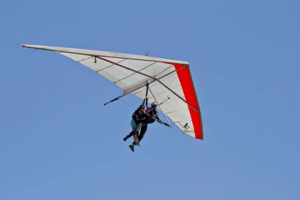 amazing-view-human-flying-hang-glider-isolated-blue-sky-background-1790025273