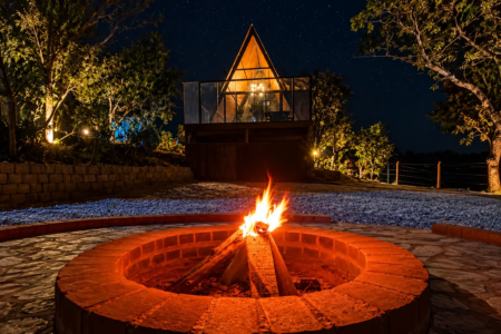 Chalé Ypê Roxo, em Pirenópolis, oferece área externa com fogueira, ambiente cercado pela natureza e estrutura voltada para hospedagem de casais (Foto: Reprodução/Airbnb)